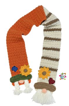 a knitted scarf with sunflowers and gnome's hats on it is shown