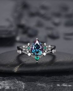 Rhodium black engagement ring like no other. This AMAZING piece of fine jewelry is the perfect expression of your eternal love. Its BLACK colors bring out the beauty of this ring. Alexandrite is the gemstone of luck, prosperity, and intellect. The alexandrite gemstone shines different colors in different lights. Under white light it shines more green and shines purple and blue under yellow light and daylight. Black gold plating pear cut lab alexandrite bridal set, black rhodium finish alexandrite wedding set, black promise ring, black wedding ring, alexandrite engagement ring set, black floral ring gift for women, girl, girlfriend, wife, mom and best friend. More black gold rings ,please click here: https://www.etsy.com/shop/ShainGem?section_id=36322715 ★Description Main ring: *Center ston Gothic Open Ring For Anniversary, Gothic Oval Wedding Ring, Silver Multi-stone Emerald Ring For Wedding, Black Multi-stone Wedding Rings, Black Multi-stone Wedding Jewelry, Black Diamond Multi-stone Rings, Gothic Wedding Ring With Gemstone, Gothic Gemstone Wedding Ring, Gothic Wedding Gemstone Ring