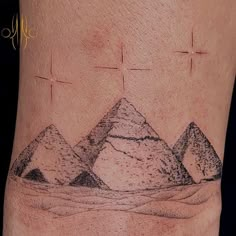 a tattoo with three pyramids on it