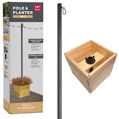 the pole and planter set is made out of wood, with a wooden box attached to it