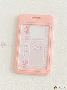 an id card is attached to a white surface with pink flowers and butterflies on it