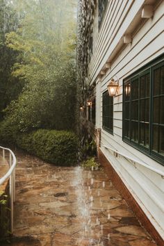 an umbrella is hanging on the side of a house