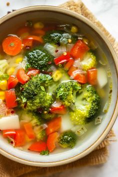 a bowl filled with broccoli, carrots and other vegetables