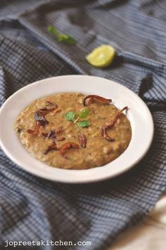 a white bowl filled with oatmeal on top of a blue towel