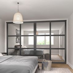 a bedroom with an open glass wall between the bed and the living room is shown