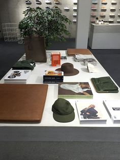 the table is covered with books and hats