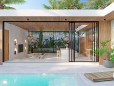 a modern house with an outdoor pool and lounge area next to the swimming pool is surrounded by palm trees