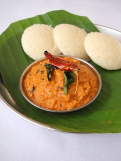 a plate with some food on it and two pieces of bread in the middle next to it