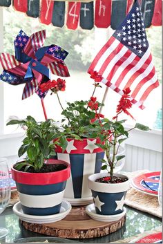 patriotic flower pots with flowers in them on a table