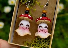 a pair of mushroom earrings in a box