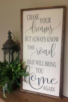 a sign that says, chase your dreams but always know the road that will bring you home again