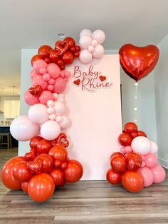 red and white balloons are arranged in the shape of a frame with hearts on it