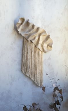 a white wall hanging with fringes on it