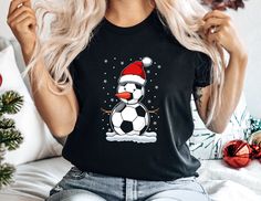 Celebrate Christmas with Your Soccer Snowman Shirt!  🎅 Show off your love for soccer with our 'Soccer Snowman Shirt.'  🎄 Featuring a cute design of a snowman made out of a soccer ball, it's perfect for a soccer festive shirt and football Christmas.  🎁 This shirt adds a fun and festive touch to your soccer lover apparel.  ❄️ Ideal for the holiday season, this shirt is a must-have for Christmas.  🎄 Add a cool and cozy shirt to your wardrobe with this soft and adorable Christmas tee.  🎅 Makes a great gift for anyone who loves soccer and football.  🎁 Whether you're playing soccer or enjoying the holidays, this awesome tee is perfect for Christmas.  Celebrate Christmas with joy in our 'Soccer Snowman Shirt'! 🌈 Shirt Colors: Check out the image to see our full range of available shirt col Ballet Shirts, Football Christmas, Snowman Shirt, Playing Soccer, Turkey Shirts, Christmas Party Shirts, Santa Shirts, Festival Shirts, Xmas Shirts