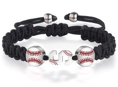 a baseball bracelet with the number one on it and two ball charms attached to it