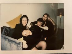 an old photo of three women sitting on a couch with their arms around each other