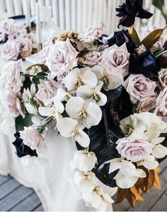 the flowers are arranged on the table ready to be placed in the centerpieces