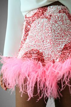 Glam your look in our Bubblegum Swirl Sequin Feather Shorts. This piece has an all-over two-tone pink and white sequin swirl motif design with feather ostrich trim at the hem. The fabric is stretchy to flatter your curves and has an elastic waist for easy wearing. Perfect for your special events such as a birthday, wedding events, date nights, and much more.DetailsShorts: StretchShell Fabric Content: Nylon/SpandexLining Content: Polyester/SpandexCare Instruction: Hand Wash or Dry cleanFit•True t Feather Shorts, Printed Summer Shorts, Hen Party Outfits, Pink Passion, Feather Skirt, Party Outfits For Women, Sequin Outfit, Flamingo Party, Pink Swirls