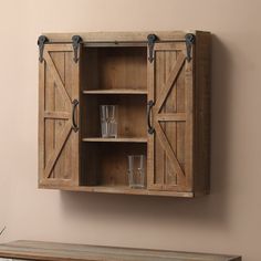 an old wooden cabinet with two glasses on it