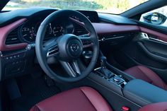 the interior of a sports car with red leather seats and steering wheel, dashboard lights, and dash board