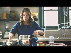 a woman is preparing food in the kitchen