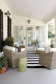 the front porch is decorated with wicker furniture