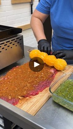 a person preparing food on top of a wooden cutting board