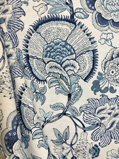 a blue and white floral print fabric with large flowers on the front, in full bloom