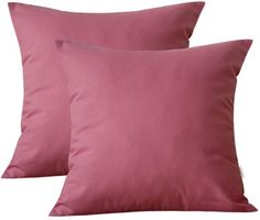 two pink pillows sitting next to each other