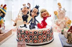 a group of figurines sitting on top of a cake