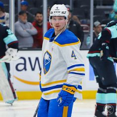 a hockey player standing on the ice with his hands in his pockets and looking at the camera