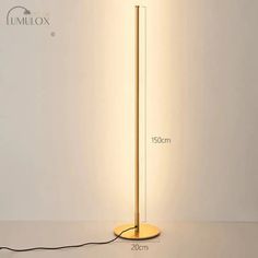 the floor lamp has a dim light on it and is next to a white wall