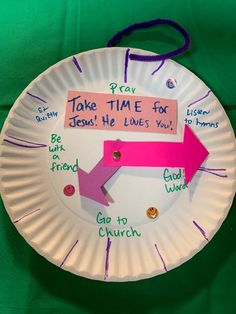 a paper plate with a pink arrow and some words on it that say take time for jesus he loves you