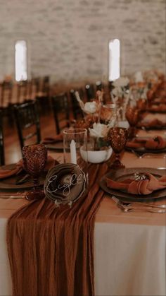 the table is set with plates and place settings