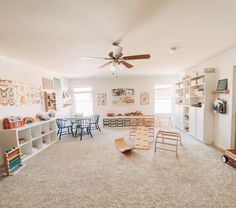 a living room filled with lots of furniture and decor on top of carpeted floors