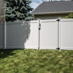 a white fence in front of a house