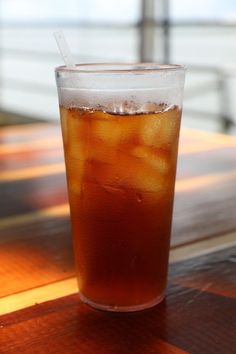 an iced drink sitting on top of a wooden table