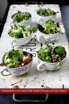 several bowls filled with salad sitting on top of a table