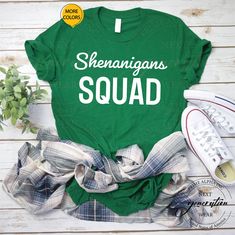 shamrock t - shirt with the words shamrocks and shenngans on it next to some shoes