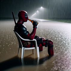 a deadpool man sitting in a chair drinking from a beer bottle while it rains