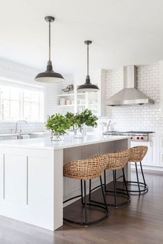 a kitchen island with two stools next to it and an oven in the background