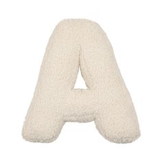 the letter shaped pillow is made out of sheepskins and has a white background