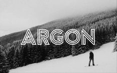 a black and white photo with the word argon in front of a person on skis