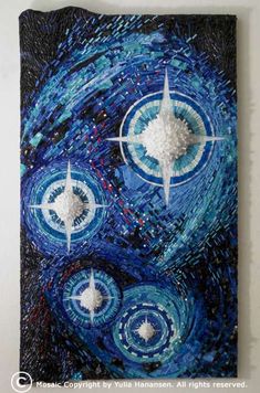 an abstract painting with blue and white circles on it's face, surrounded by stars