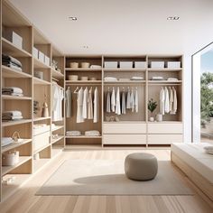 a large walk in closet with lots of shelves and clothes hanging on the walls, along with a round ottoman