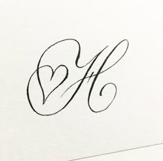 the letter m is inscribed in cursive writing with a heart on it's side