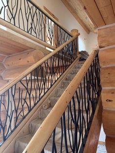 a wooden staircase with wrought iron handrails