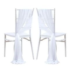 2 white chiavar chairs with sheer drapes on the back and seat covers