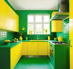 a green and yellow kitchen with white walls