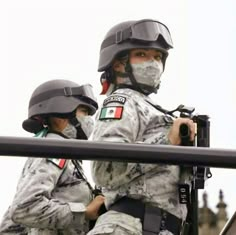 two soldiers wearing helmets and protective gear